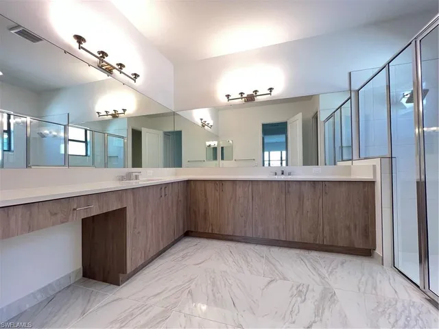 a large bathroom with a large mirror vanity and double vanity
