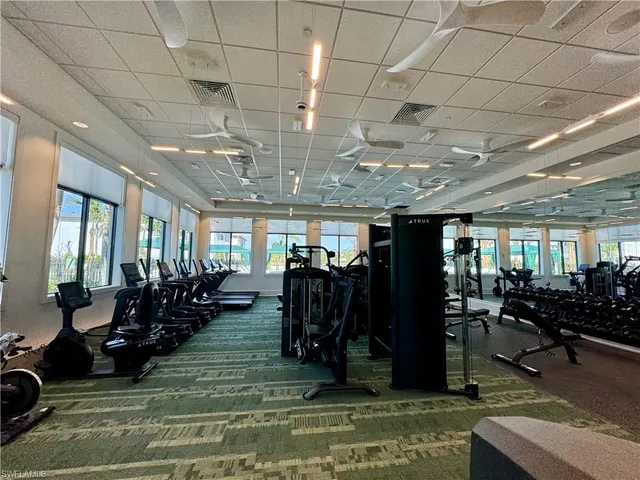 a living room with patio furniture and a flat screen tv