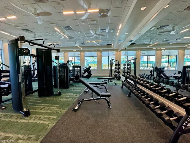 an empty room with wooden floor and chandelier
