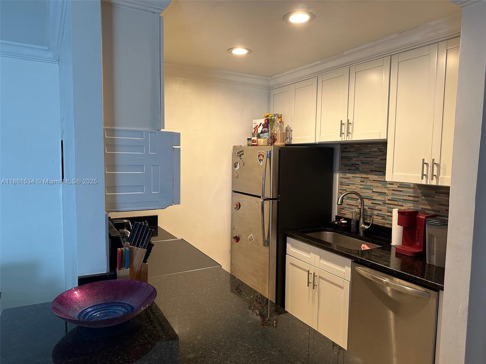 22 Crossings Circle, Unit E Boynton Beach, FL 33435 - Photo 11 of 28 a kitchen with stainless steel appliances a refrigerator sink and stove