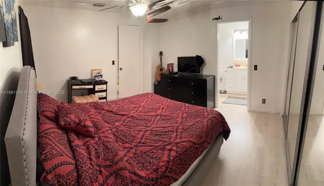 a bed sitting in a bedroom and chair