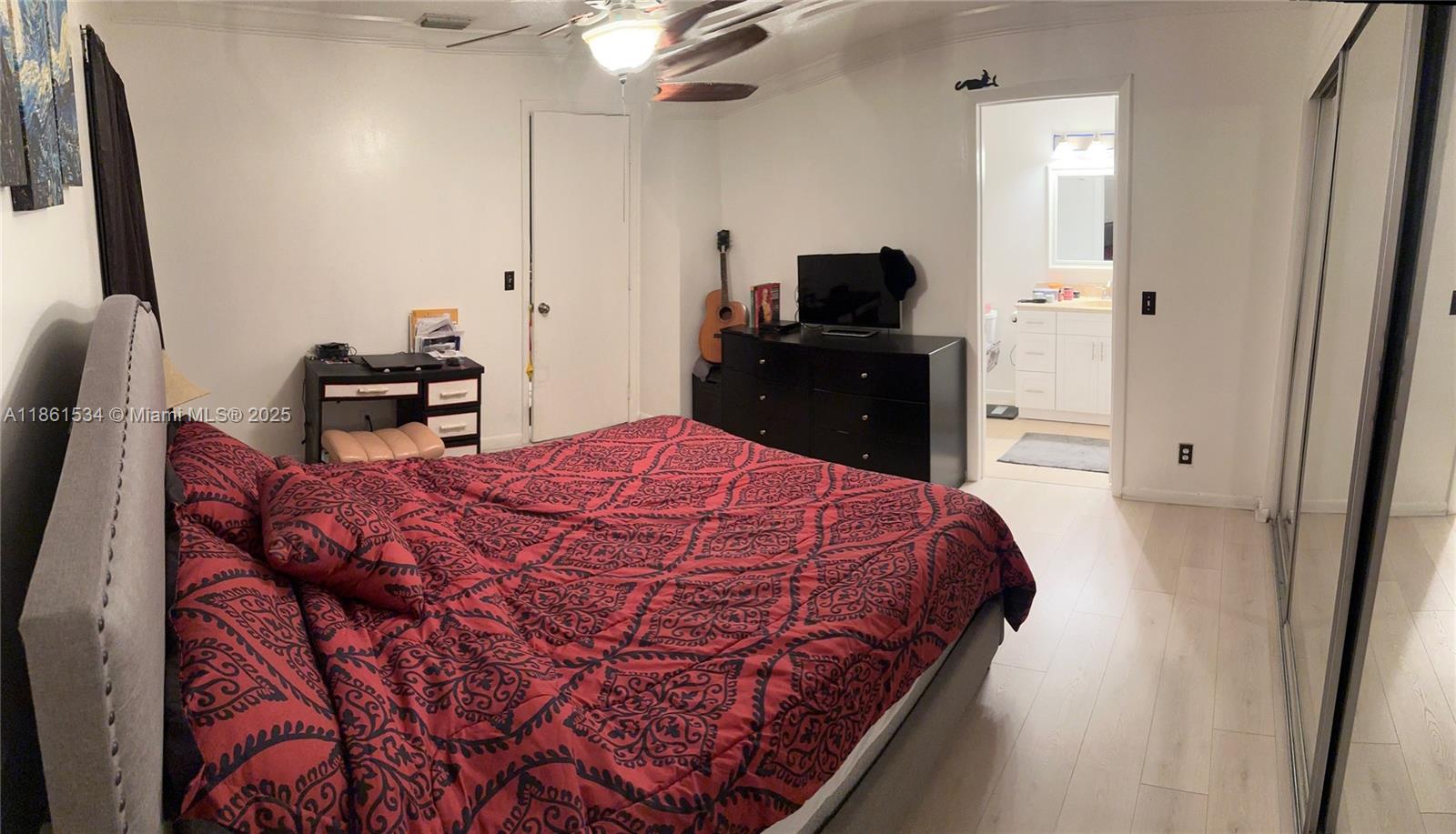 22 Crossings Circle, Unit E Boynton Beach, FL 33435 - Photo 13 of 28 a bed sitting in a bedroom and chair