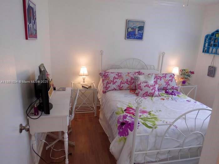 22 Crossings Circle, Unit E Boynton Beach, FL 33435 - Photo 15 of 28 a bedroom with a bed and wooden floor