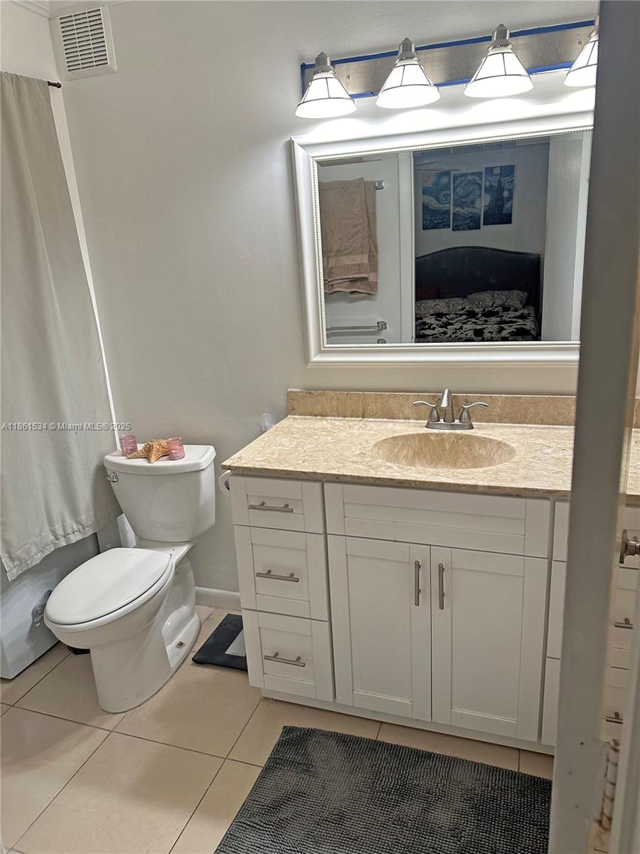 22 Crossings Circle, Unit E Boynton Beach, FL 33435 - Photo 17 of 28 a bathroom with a toilet sink and mirror
