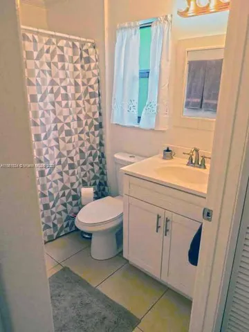 a bathroom with a sink toilet and mirror