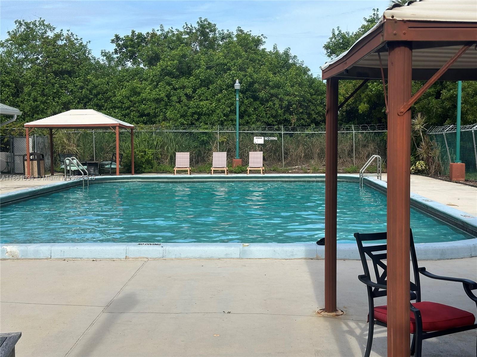 22 Crossings Circle, Unit E Boynton Beach, FL 33435 - Photo 24 of 28 a view of a house with a yard and sitting area