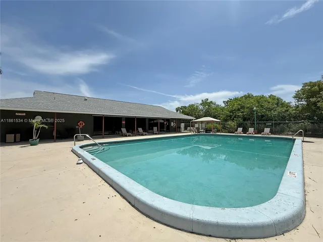 a view of a swimming pool with a yard