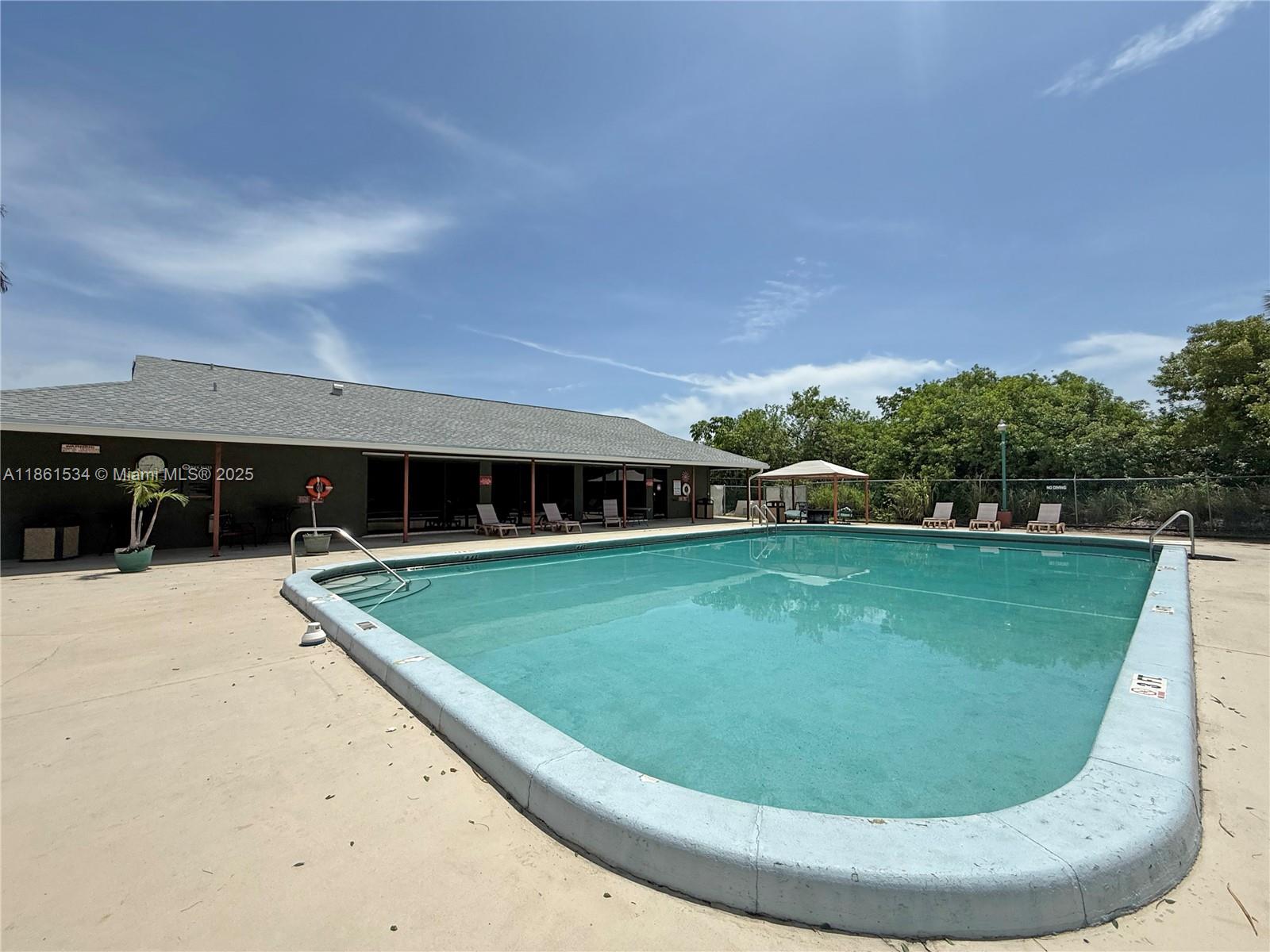 22 Crossings Circle, Unit E Boynton Beach, FL 33435 - Photo 26 of 28 a view of a swimming pool with a yard