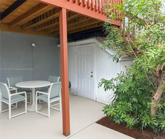 a backyard of a house with table and chairs