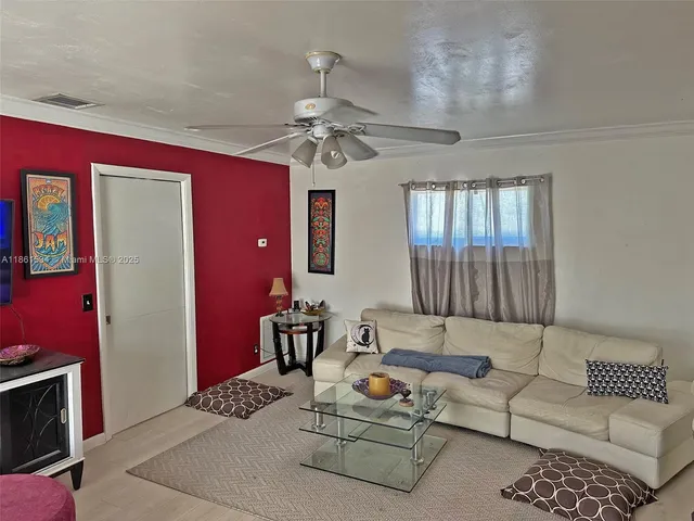 a living room with furniture a fireplace and a chandelier