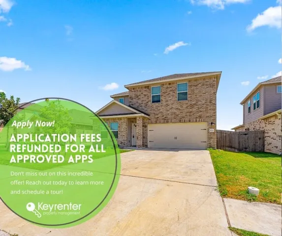 a view of a house with a backyard