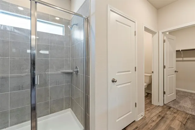 a bathroom with a glass shower door