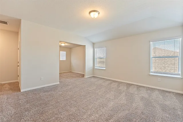 an empty room with windows and closet