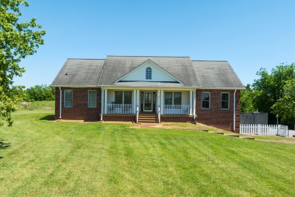 1224 Stop 30 Road Hendersonville, TN 37075 - Photo 2 of 11 a front view of a house with a garden and yard