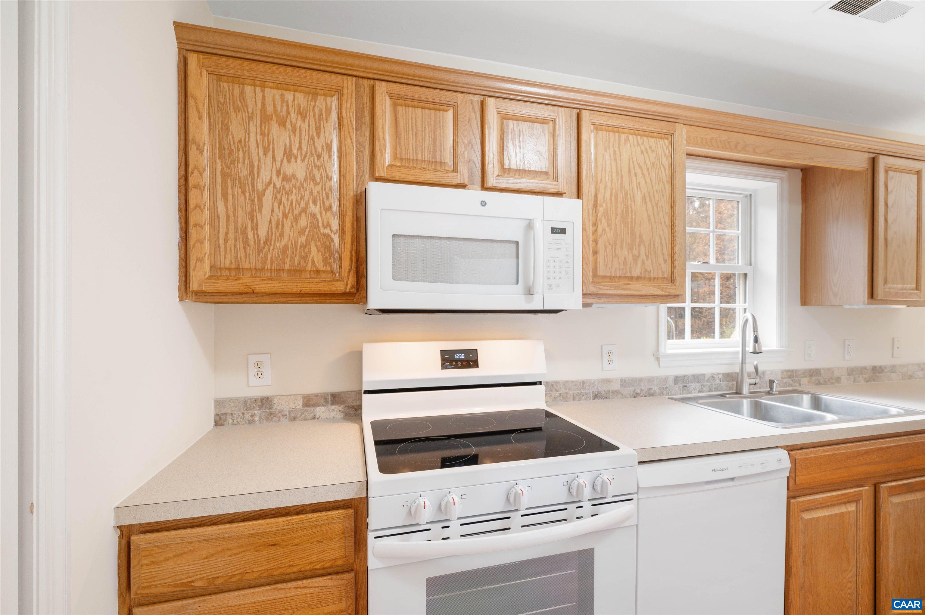 328 West Daffodil Road Ruckersville, VA 22968 - Photo 14 of 67 a kitchen with a sink cabinets and a wooden floor