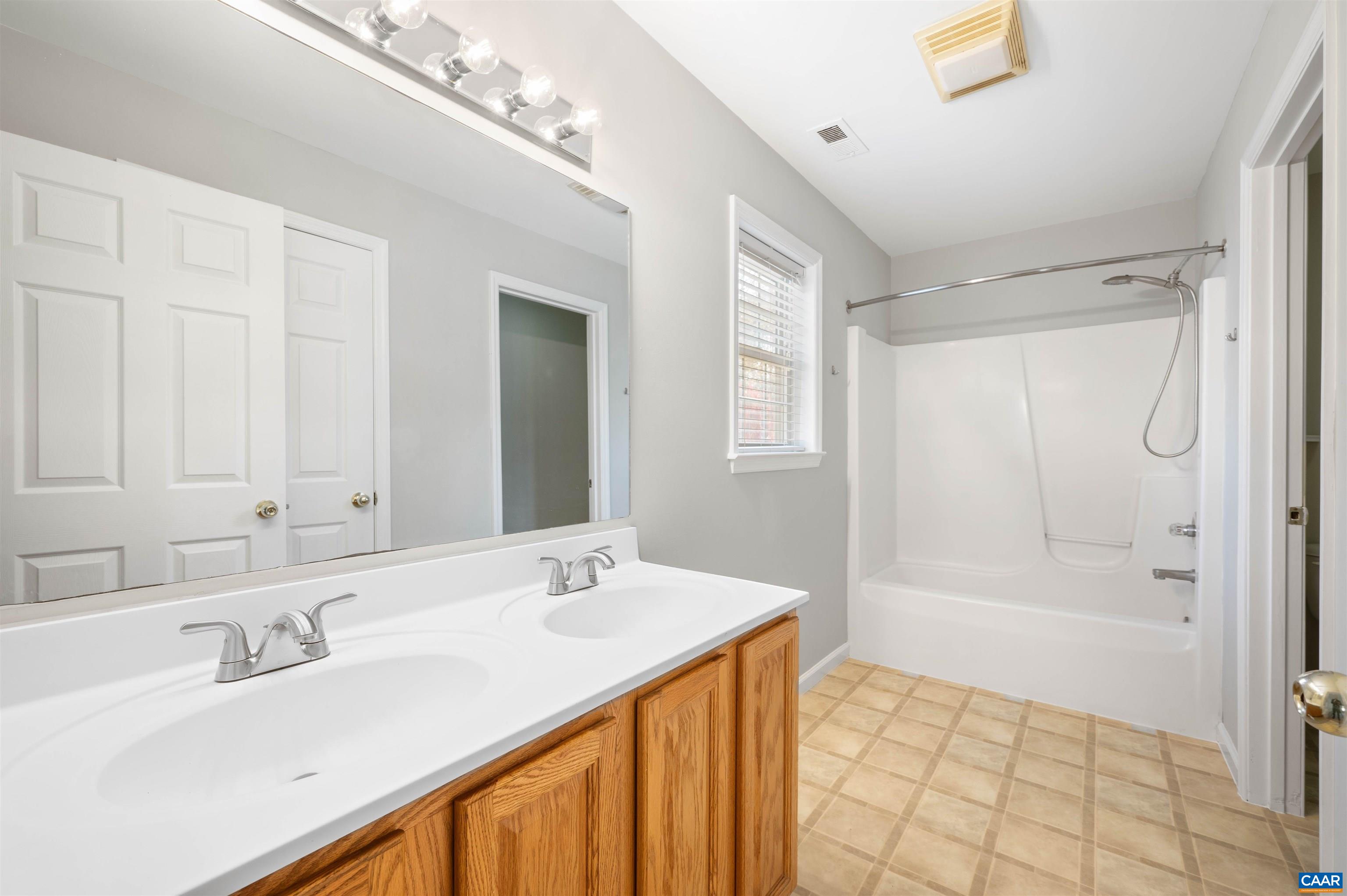 328 West Daffodil Road Ruckersville, VA 22968 - Photo 20 of 67 a bathroom with a sink double vanity granite tub shower and a mirror
