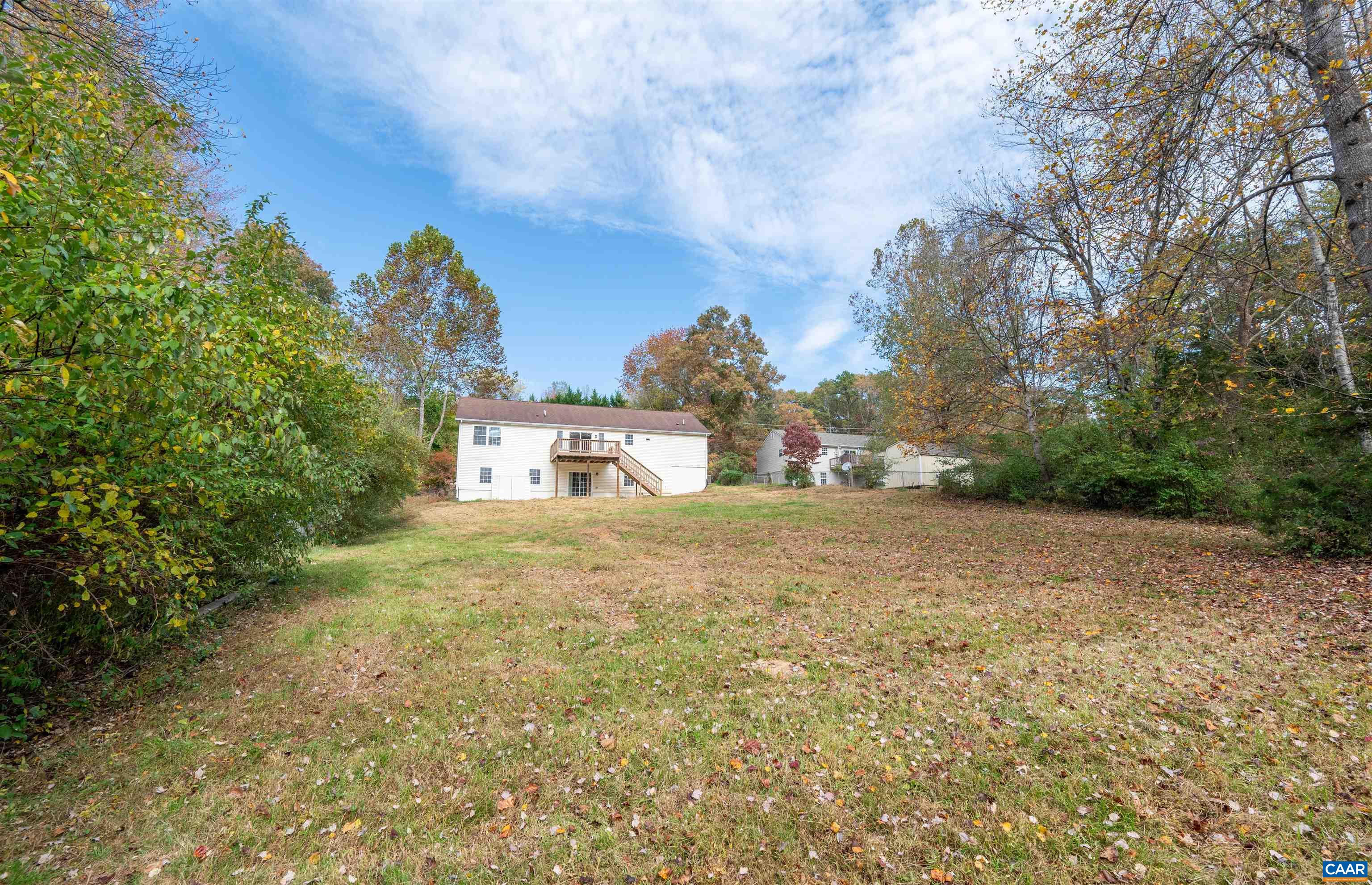 328 West Daffodil Road Ruckersville, VA 22968 - Photo 45 of 67 a view of a large house with a yard and large trees