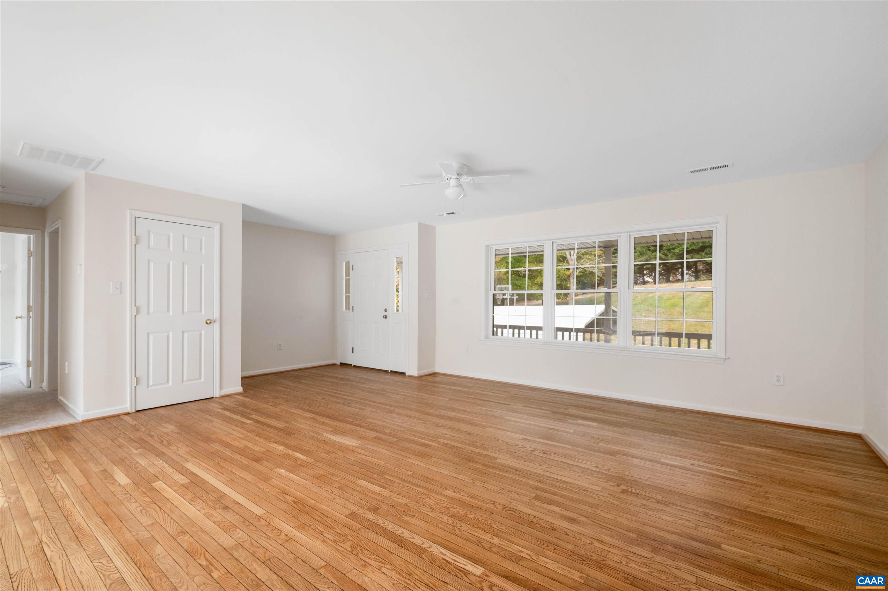 328 West Daffodil Road Ruckersville, VA 22968 - Photo 8 of 67 a view of an empty room with wooden floor and a window