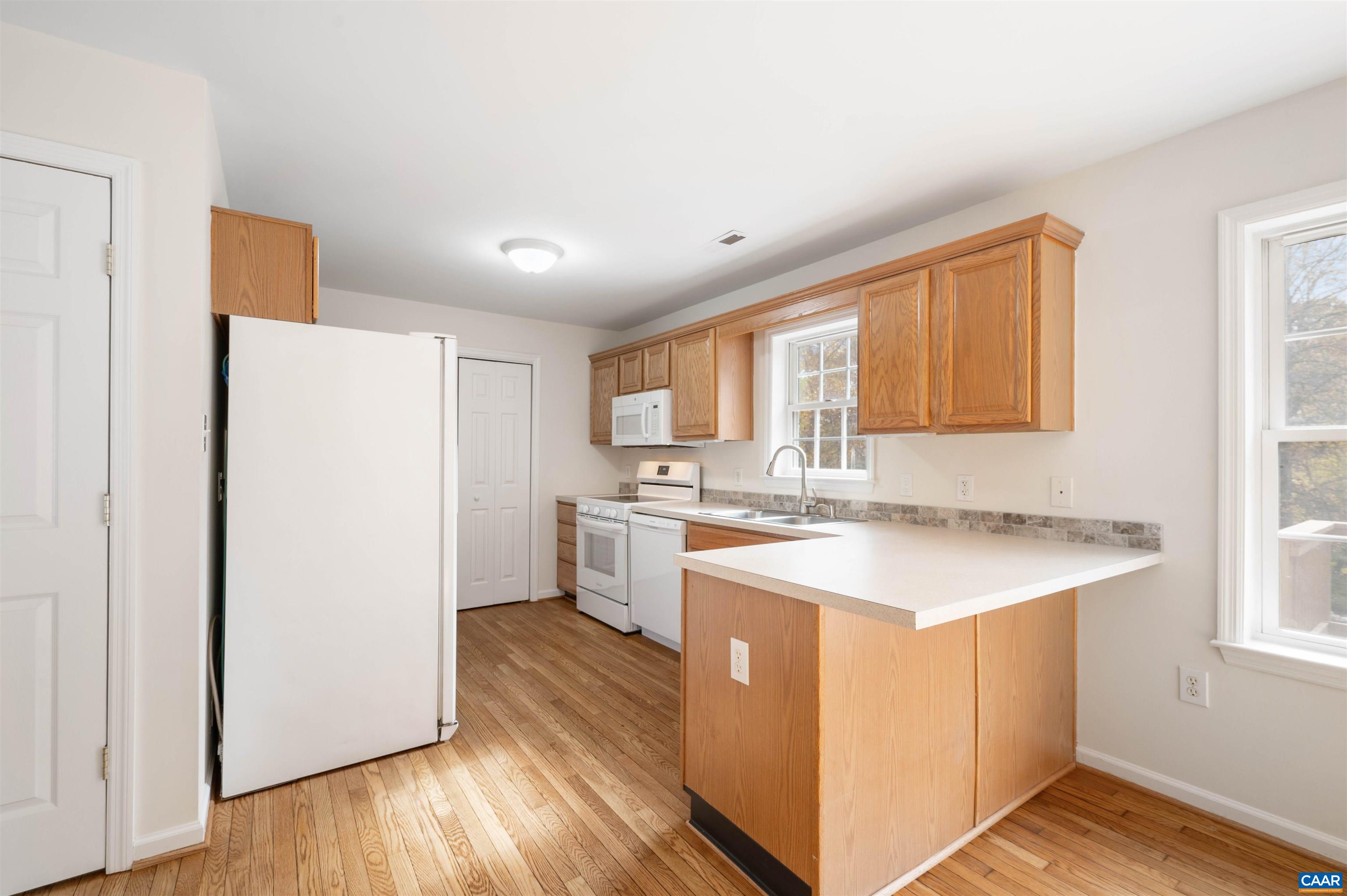 328 West Daffodil Road Ruckersville, VA 22968 - Photo 10 of 67 a kitchen with a sink a stove a refrigerator and a window