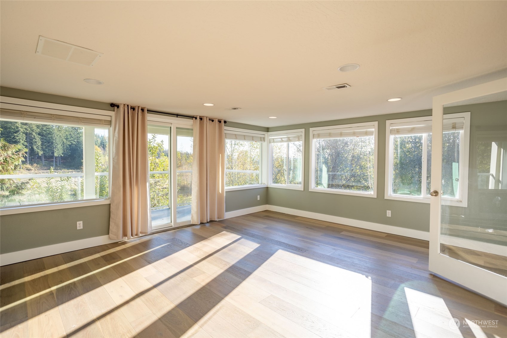 150 Logan Hill Road Chehalis, WA 98532 - Photo 13 of 40 a view of an empty room with wooden floor and a window