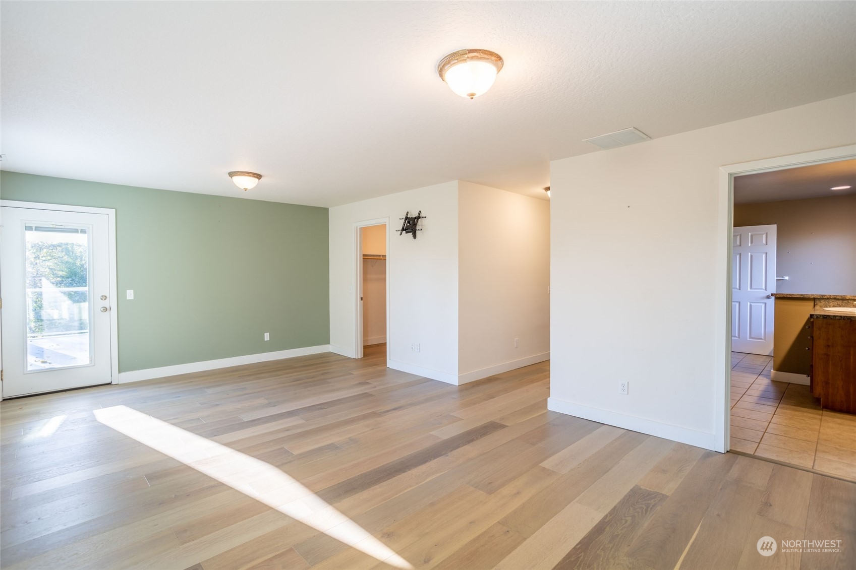 150 Logan Hill Road Chehalis, WA 98532 - Photo 17 of 40 a view of a livingroom with a flesh screen tv and wooden floor