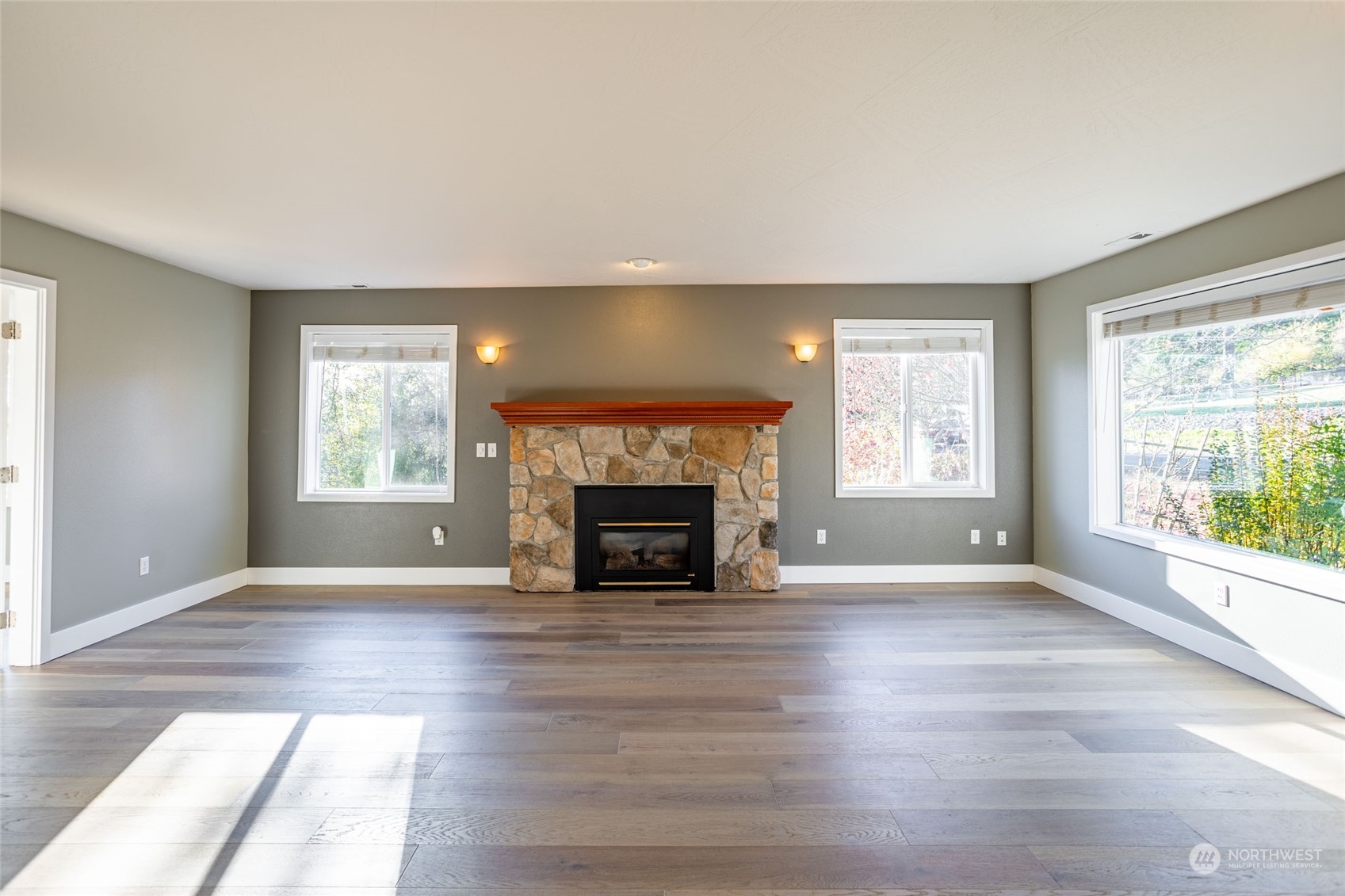 150 Logan Hill Road Chehalis, WA 98532 - Photo 4 of 40 an empty room with windows and a fireplace