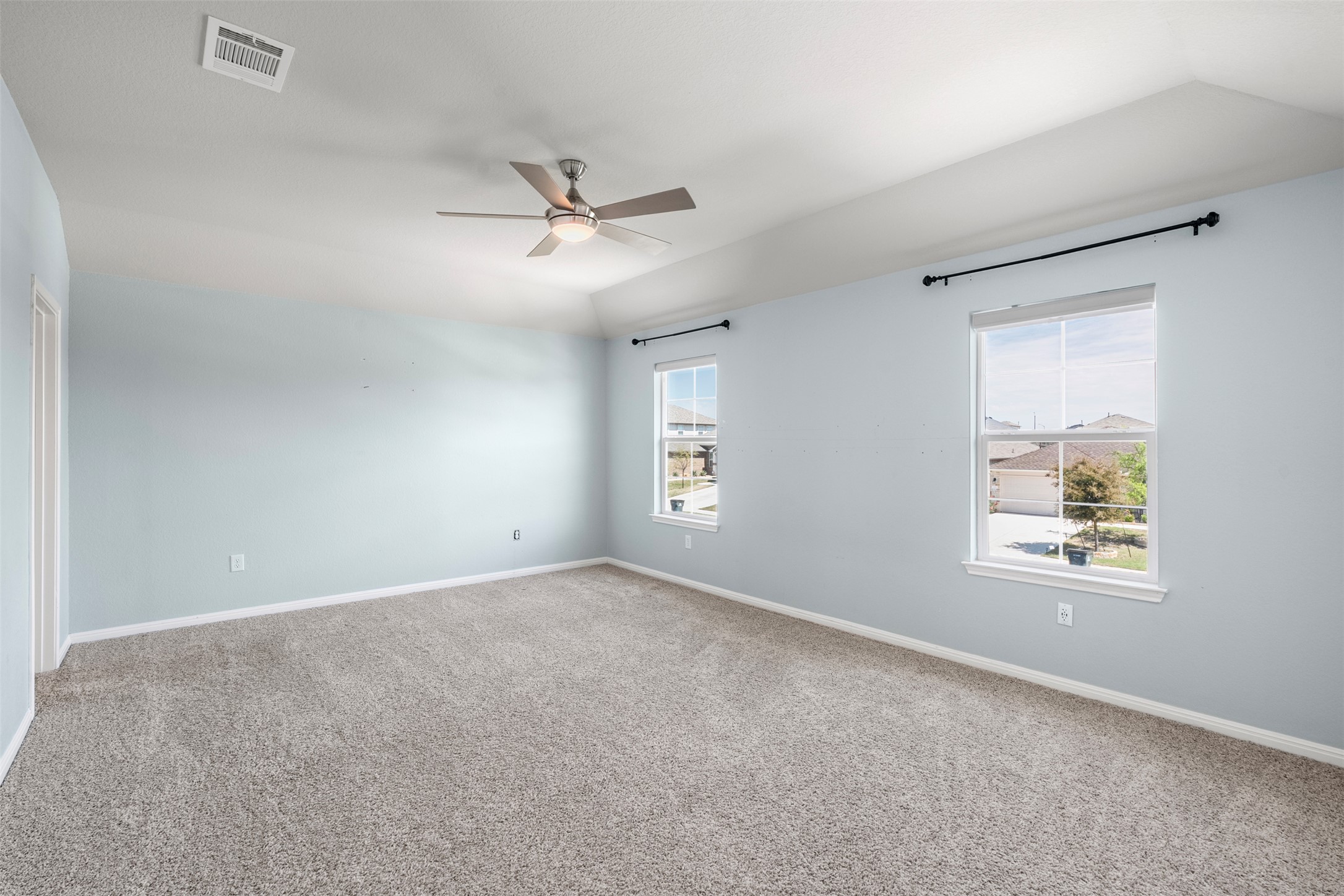 120 Ellinger Road Georgetown, TX 78626 - Photo 5 of 28 Spacious room featuring vaulted ceilings, light blue walls, and grey carpeting