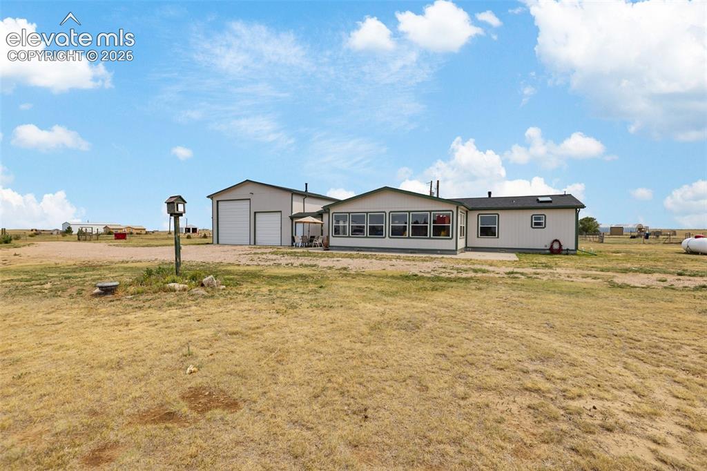 1350 South Calhan Highway Yoder, CO 80864 - Photo 42 of 45 Single-story property with light-colored siding and a dark roof