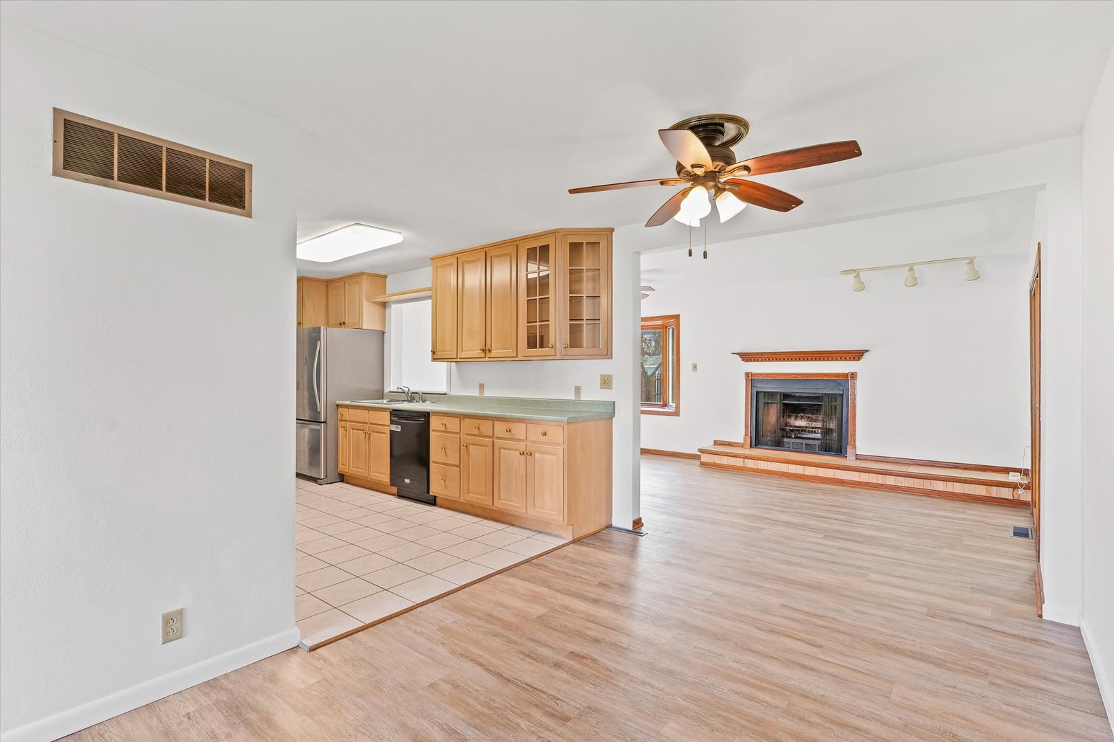 103 West Jefferson Street Philo, IL 61864 - Photo 11 of 36 a kitchen with stainless steel appliances granite countertop a stove top oven a sink and a wooden floor