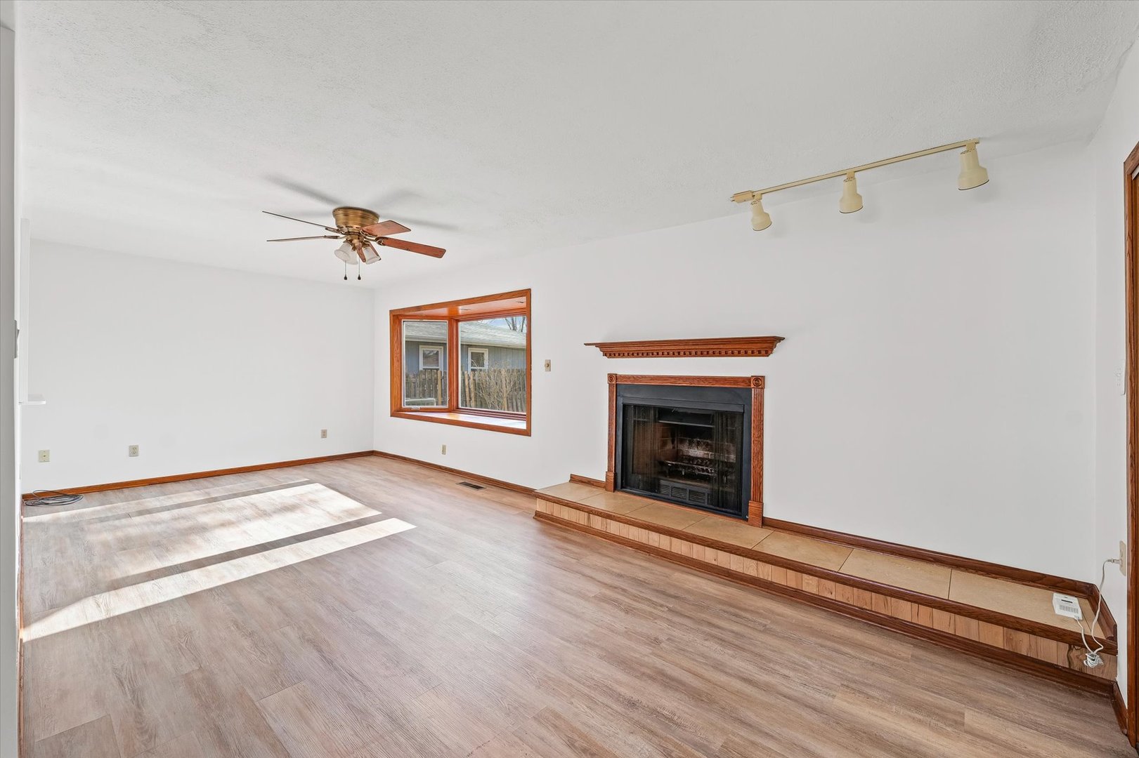 103 West Jefferson Street Philo, IL 61864 - Photo 13 of 36 a view of an empty room with a fireplace and wooden floor