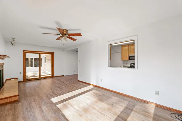 a view of a livingroom with a ceiling fan and window