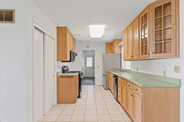 a kitchen with stainless steel appliances granite countertop a stove and a sink