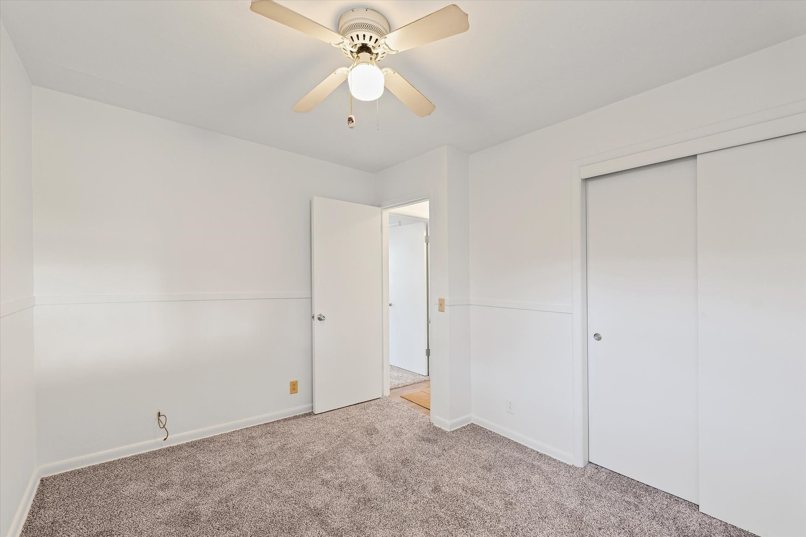 103 West Jefferson Street Philo, IL 61864 - Photo 26 of 36 an empty room with a chandelier fan and windows