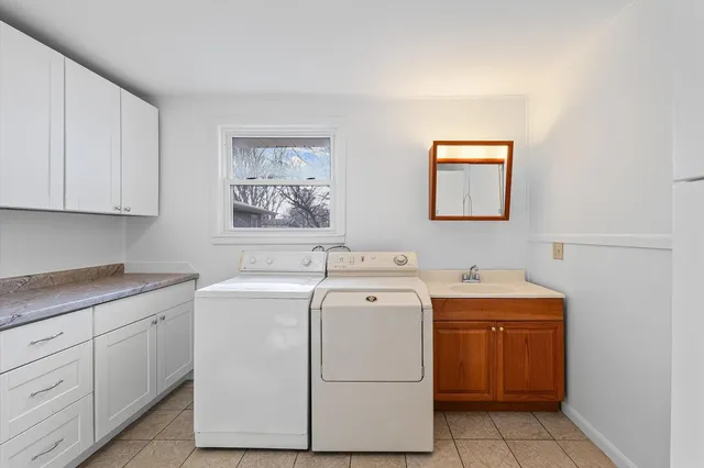 a bathroom with a granite countertop shower a toilet and sink