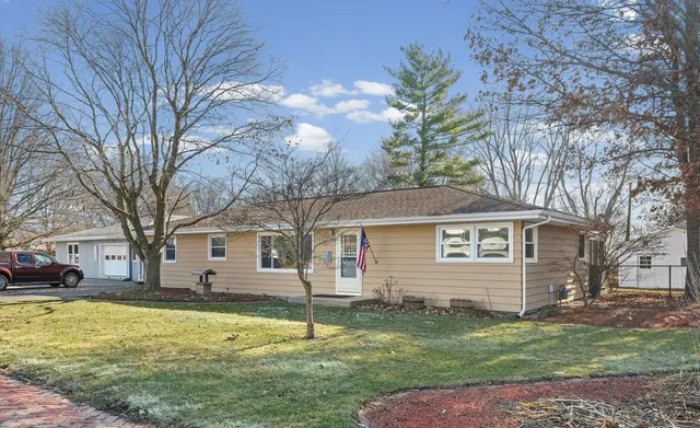 a view of a house with a backyard