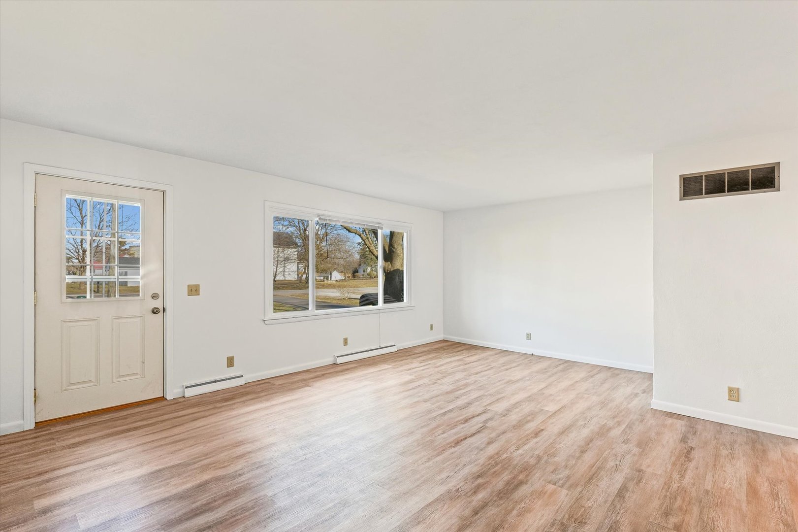 103 West Jefferson Street Philo, IL 61864 - Photo 7 of 36 an empty room with wooden floor and window