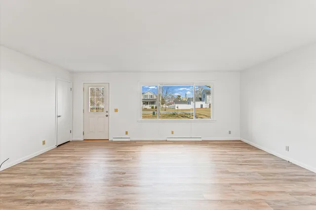 an empty room with painting on the wall