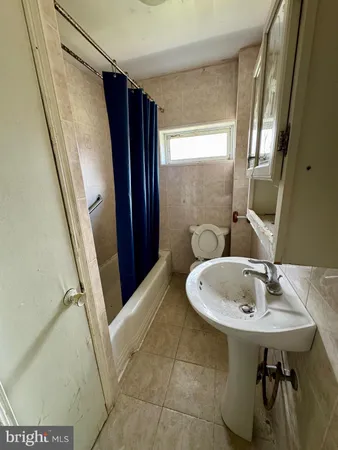 a view of a room with a window and a ceiling fan