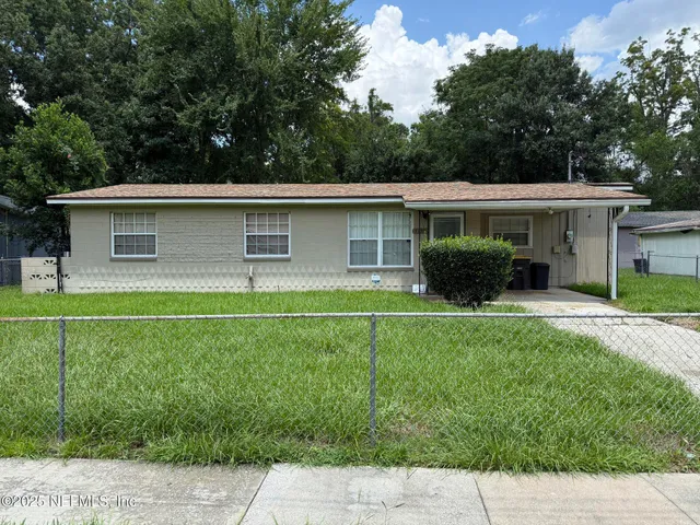 a front view of house with yard and green space