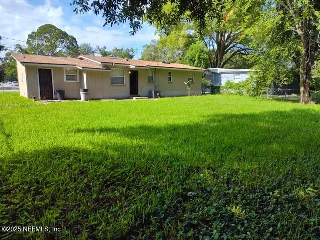 a front view of house with yard and green space