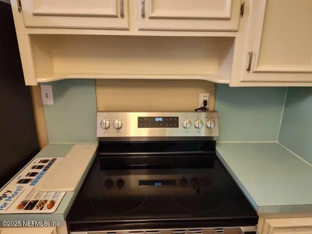 a stove top oven sitting inside of a kitchen