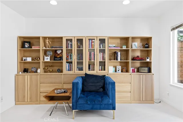 a living room with furniture and a bookshelf