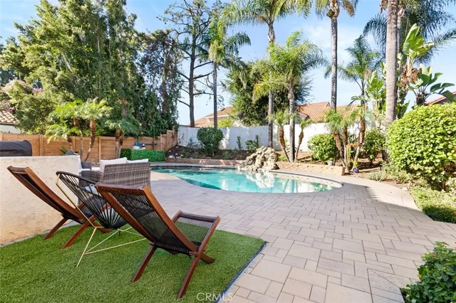 a view of a swimming pool with lounge chair