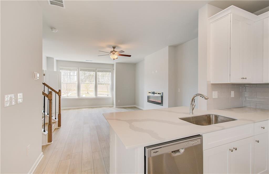 1903 Daybreak Lane Newnan, GA 30265 - Photo 13 of 29 a kitchen with a sink a stove and cabinets