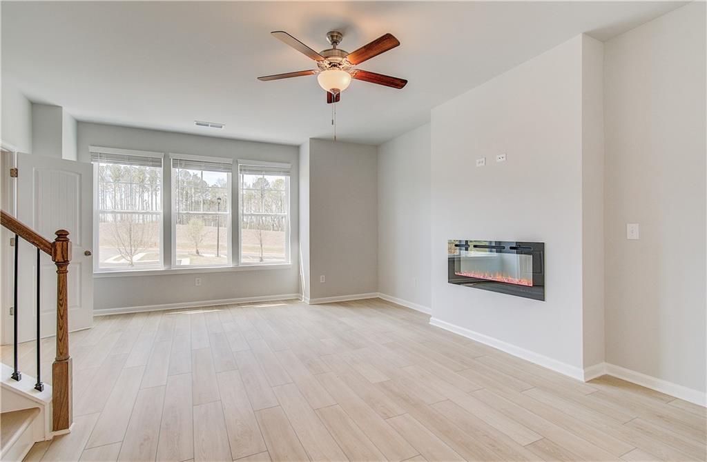 1903 Daybreak Lane Newnan, GA 30265 - Photo 14 of 29 a view of an empty room with a window and a kitchen