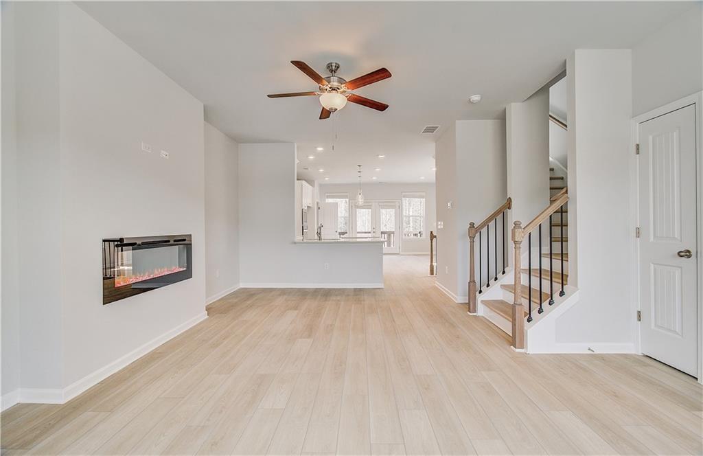 1903 Daybreak Lane Newnan, GA 30265 - Photo 18 of 29 a view of a hallway with wooden floor and chandelier fan
