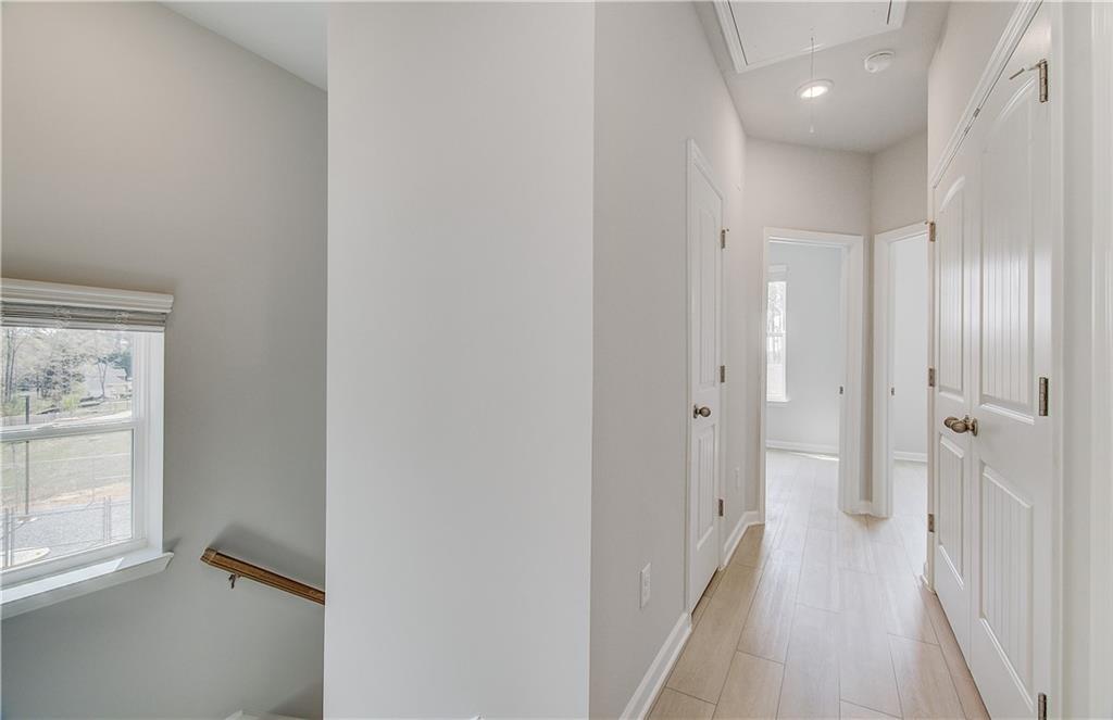 1903 Daybreak Lane Newnan, GA 30265 - Photo 19 of 29 a view of a hallway with wooden floor and a bathroom