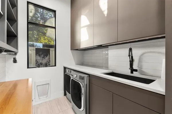 a living room with fireplace furniture and a large window