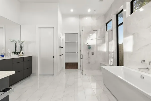 a large bathroom with a granite countertop sink mirror and shower