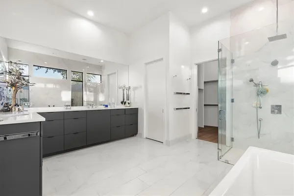 a large bathroom with a large tub and sink